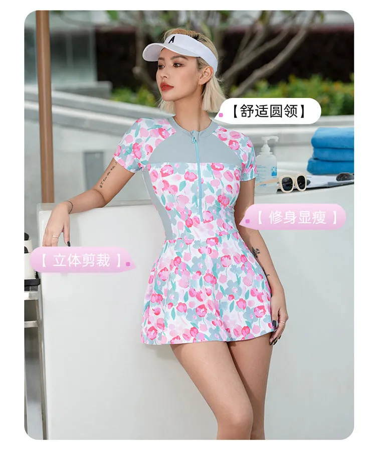 Plus size women's one-piece swimsuit with a printed colour pattern, shown on a mannequin.