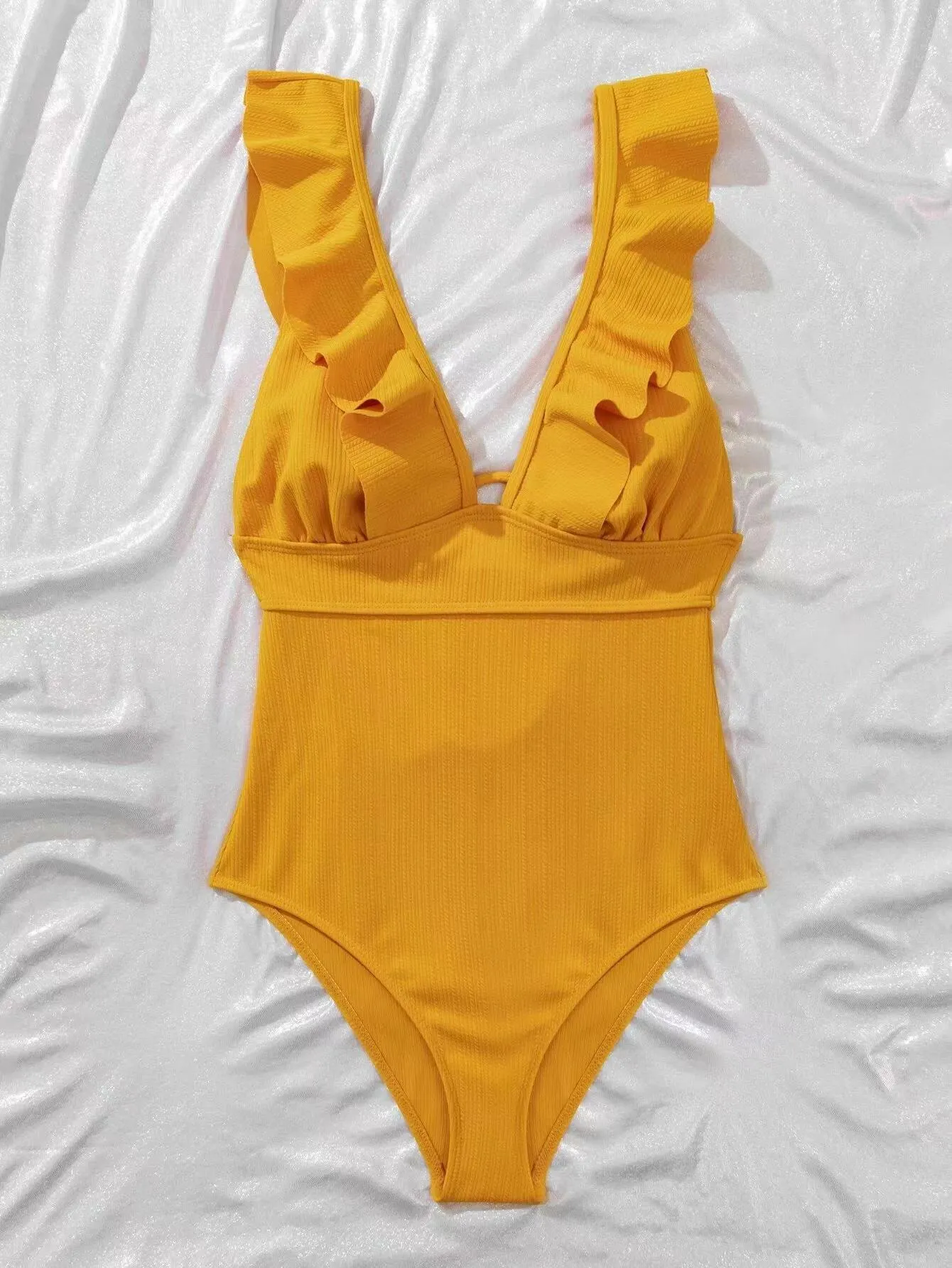 Black one-piece swimsuit for women with ruffled shoulder straps and decorative lace across the back.