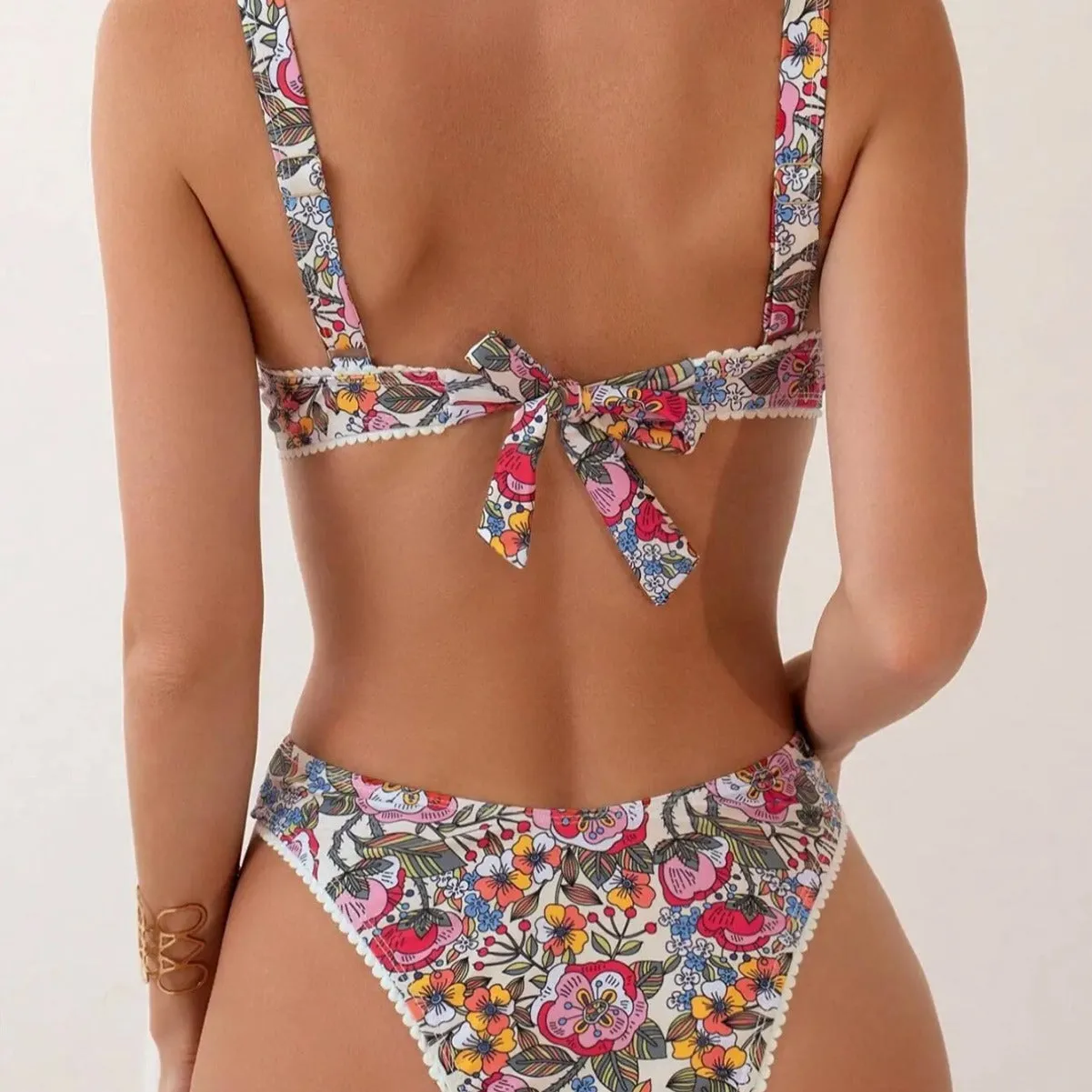 Women's floral print bikini with steel bracket push-up and tied sides, shown in high-waist briefs style.