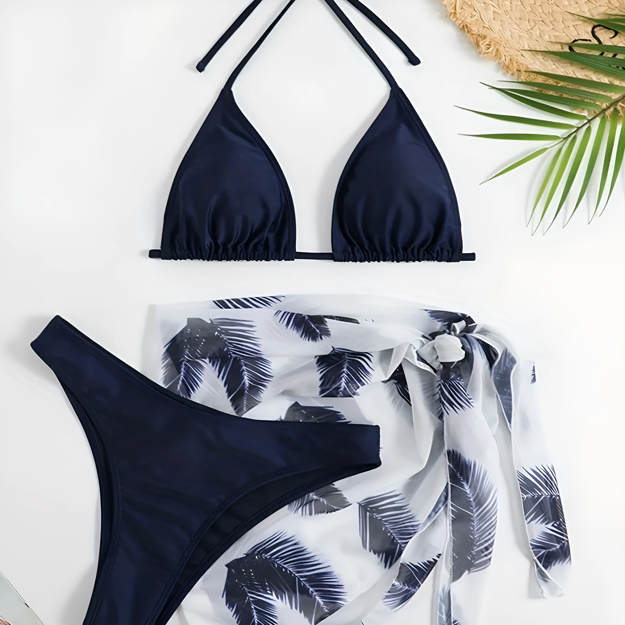 Orange three-piece bikini swimsuit set with a printed gauze skirt on a white background