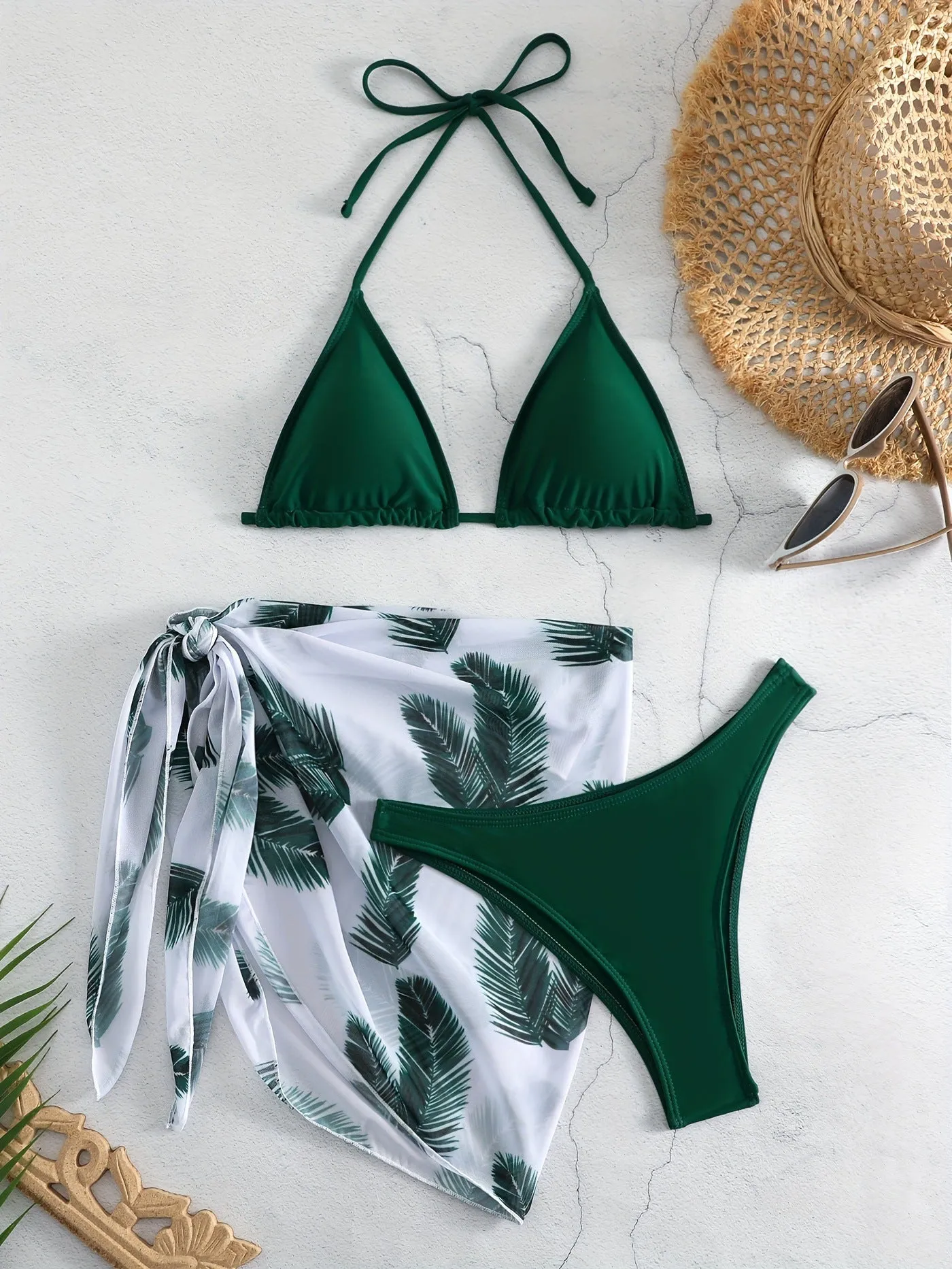 Orange three-piece bikini swimsuit set with a printed gauze skirt on a white background
