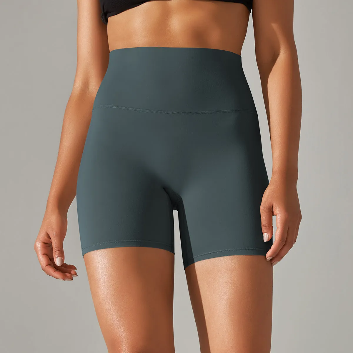 Women's high waist fitness tights in dark green, hip-length cut, for running and gym wear.