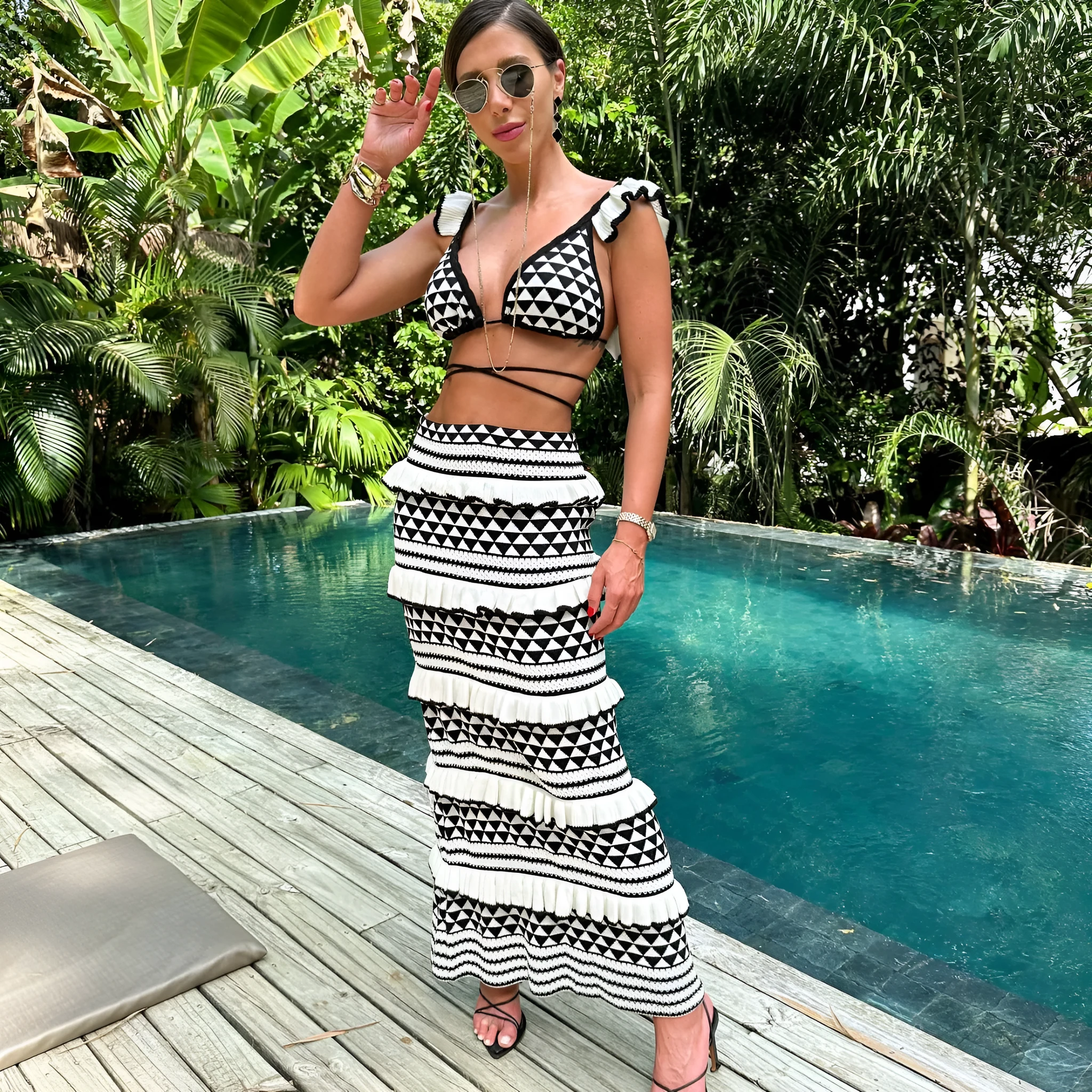 Women's black and white striped bikini set with ruffled spaghetti straps and matching long knitted cotton skirt