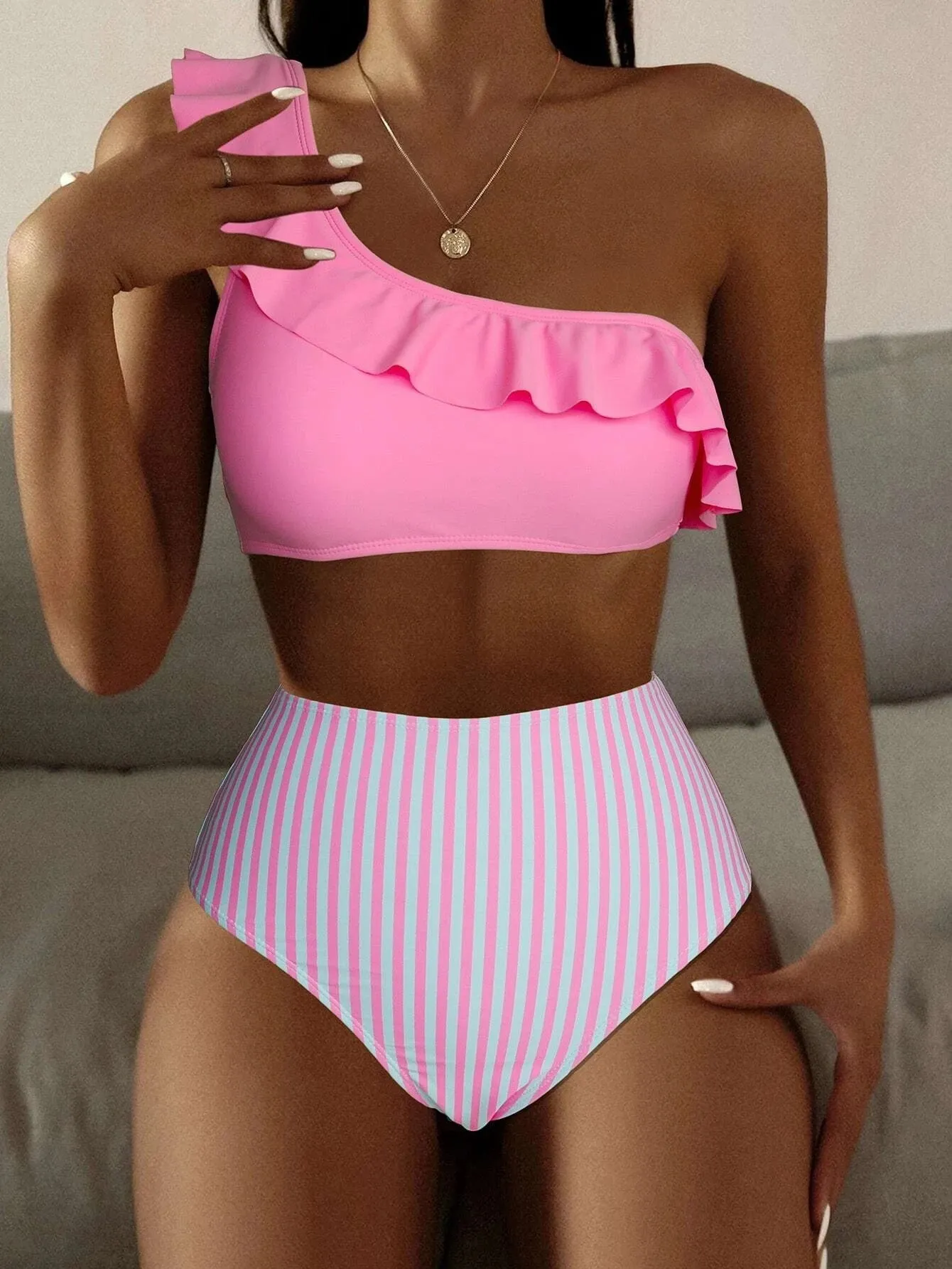 Women's striped and solid colour bikini swimsuit set on a white background.
