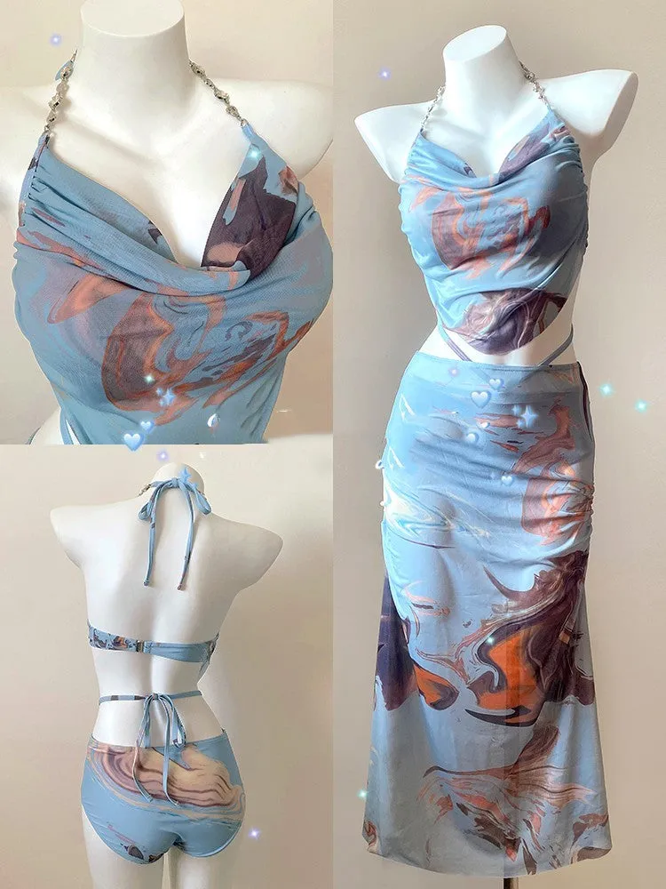 Women's blue printed three-piece bikini set with triangle top featuring steel wire support and a detachable skirt.