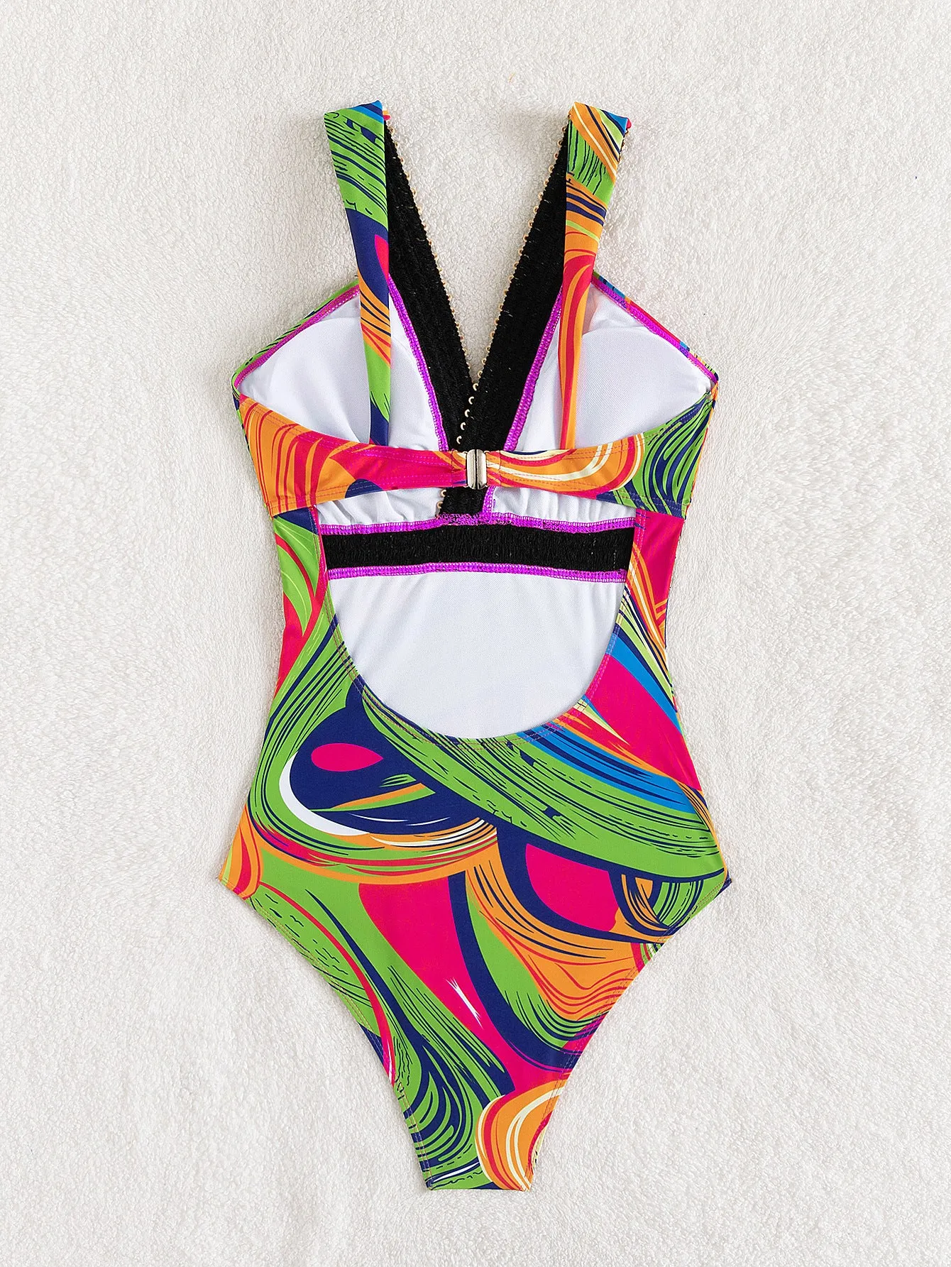 Women's deep V-neck one-piece swimsuit with spaghetti straps in a printed pattern