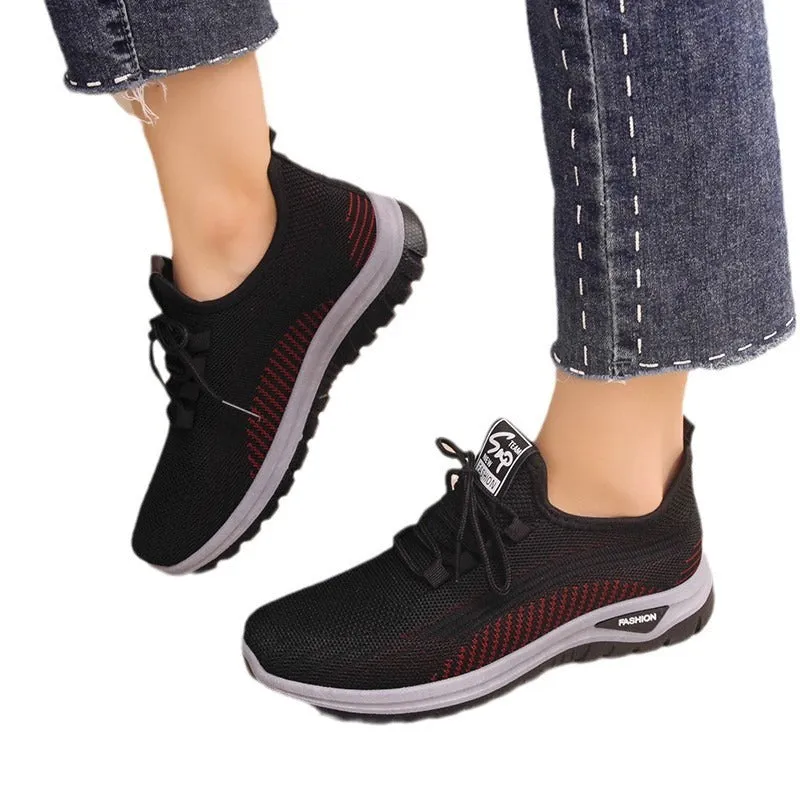 Women's black mesh sneakers with round toe and cross strap detail on rubber sole