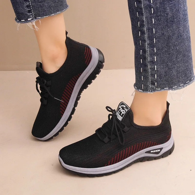 Women's black mesh sneakers with round toe and cross strap detail on rubber sole