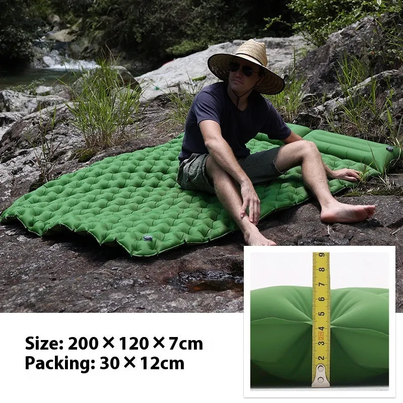 Dark blue double air mattress with built-in pump inflated on a floor, showing integrated pillow.