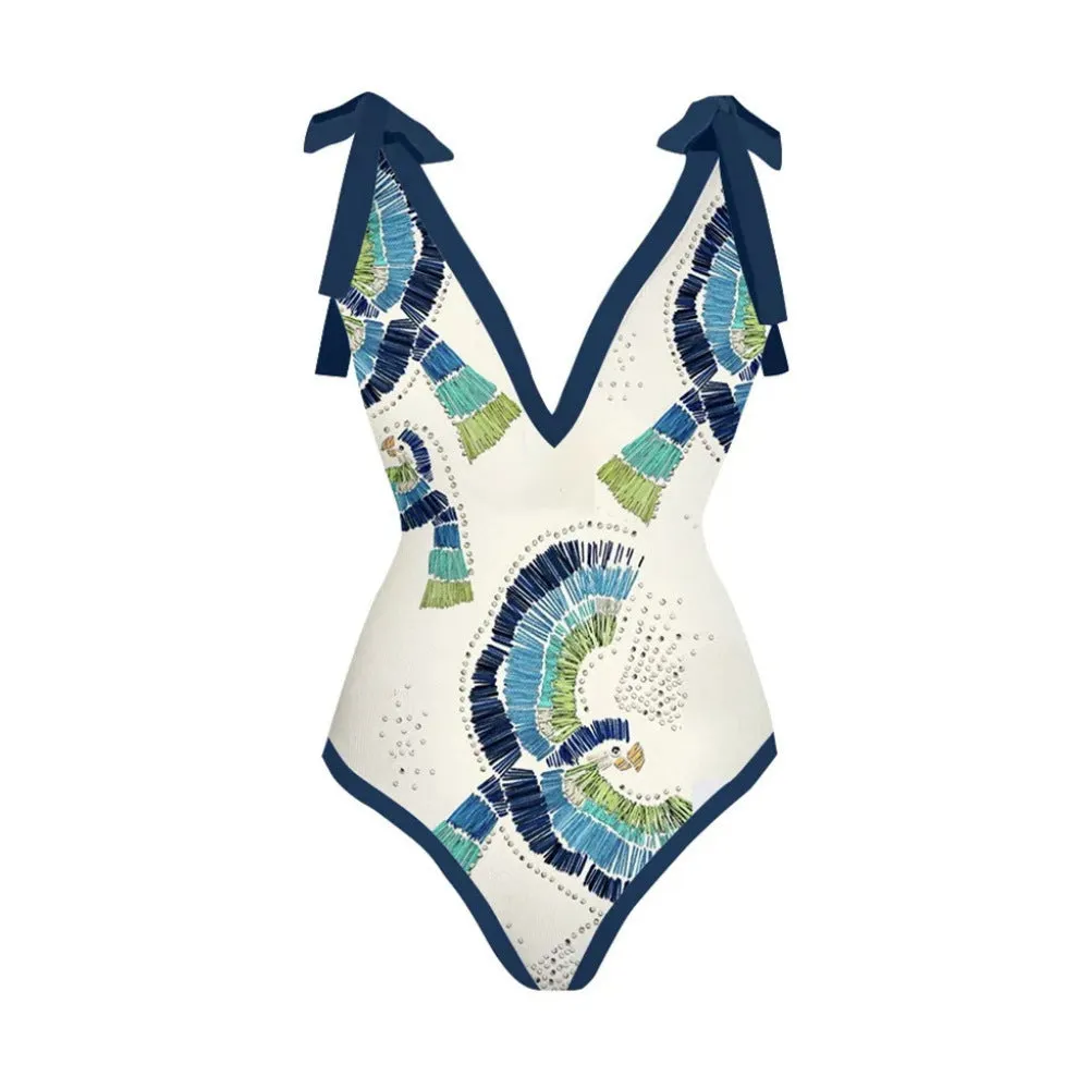 Blue retro one-piece swimsuit with bikini bottom and matching gauze skirt laid flat