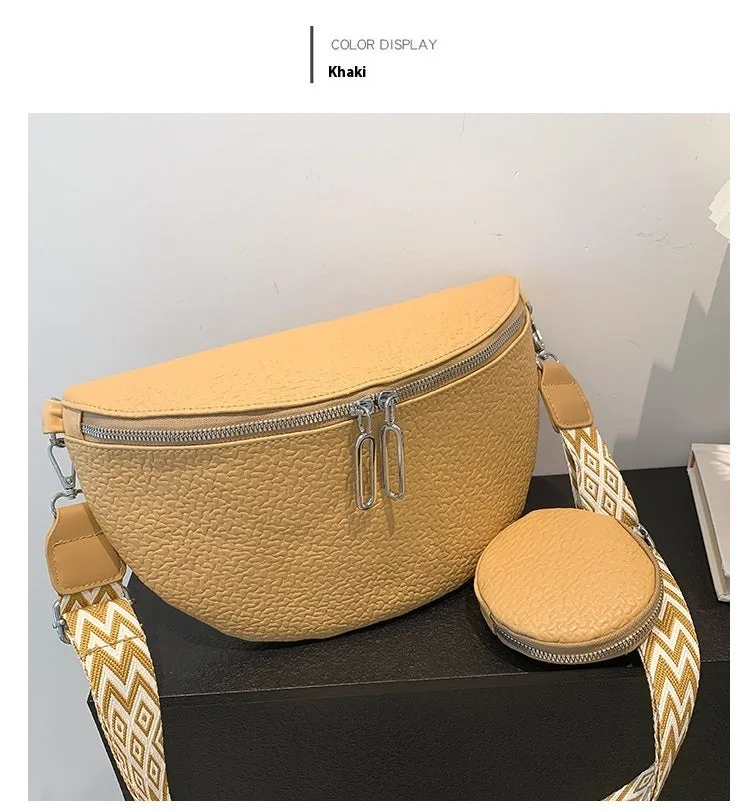 Solid colour women's crossbody bag with saddle lock zipper texture in a horizontal square clamshell shape.