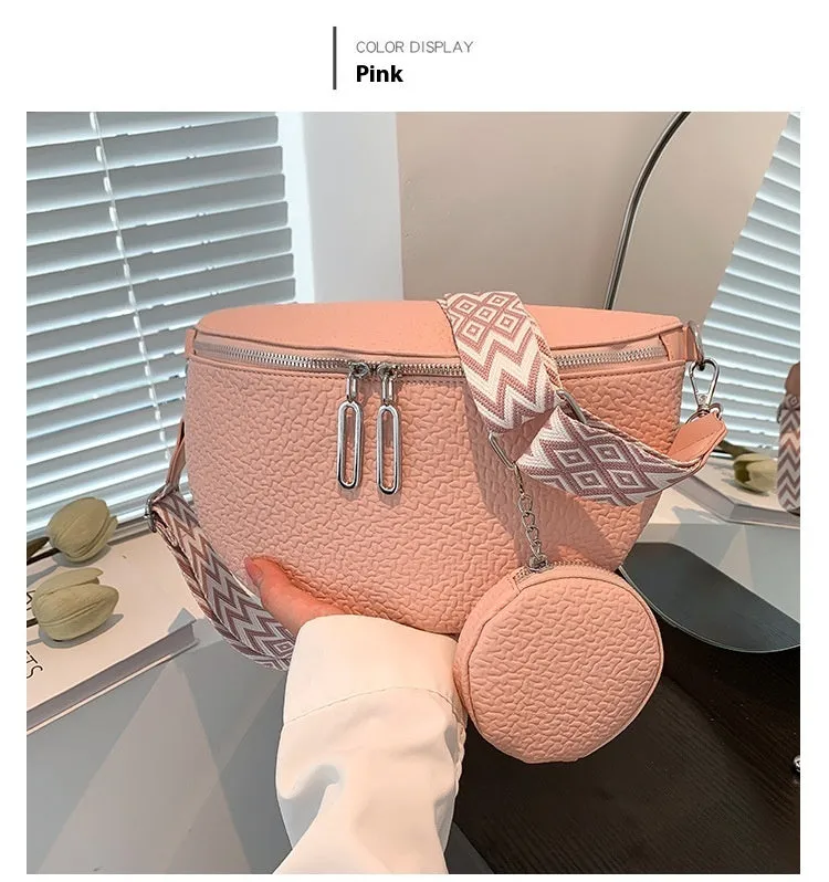 Solid colour women's crossbody bag with saddle lock zipper texture in a horizontal square clamshell shape.