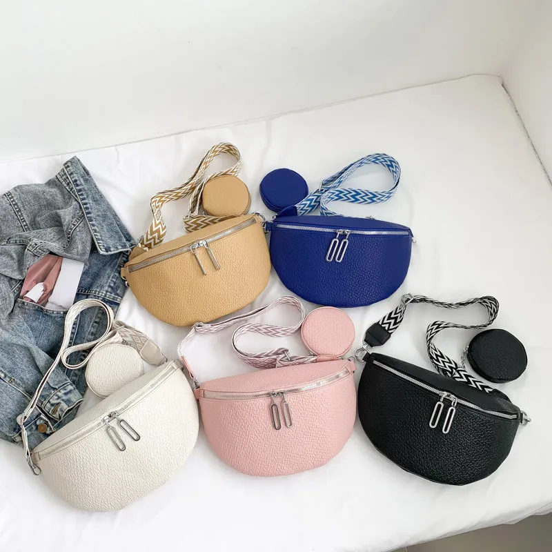 Solid colour women's crossbody bag with saddle lock zipper texture in a horizontal square clamshell shape.