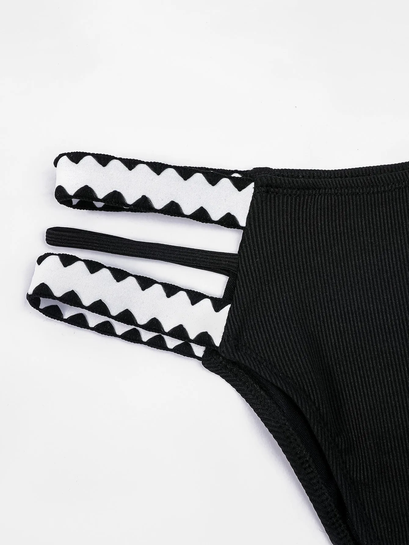 Black women's hollowed-out split swimsuit bikini set on a mannequin.