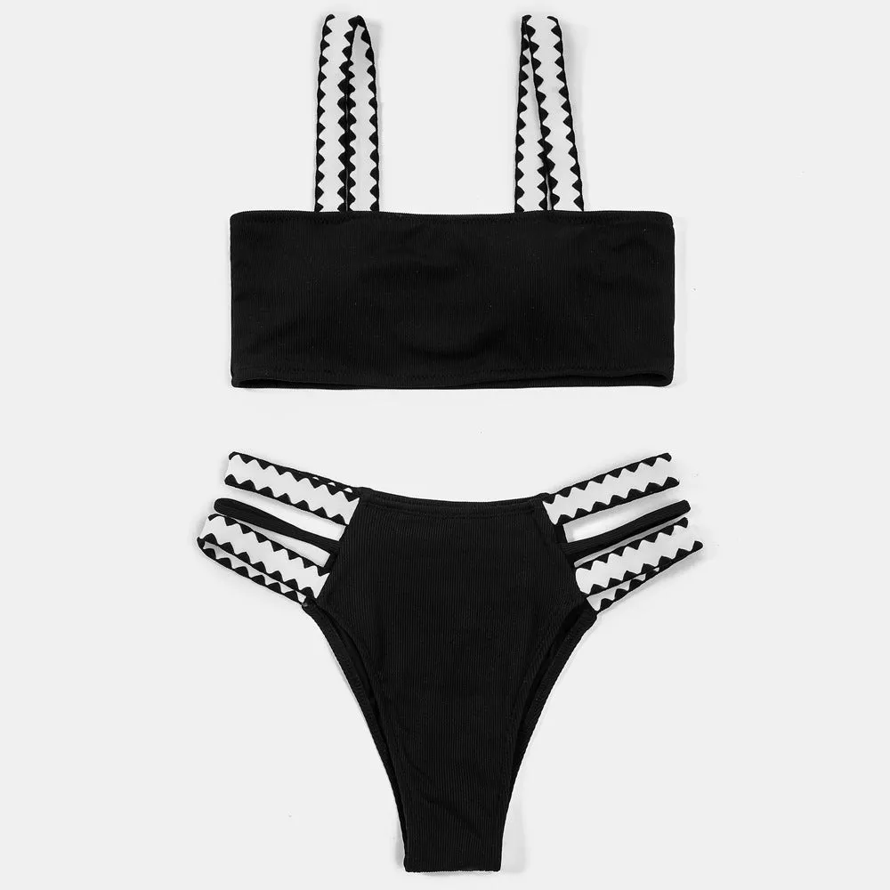 Black women's hollowed-out split swimsuit bikini set on a mannequin.