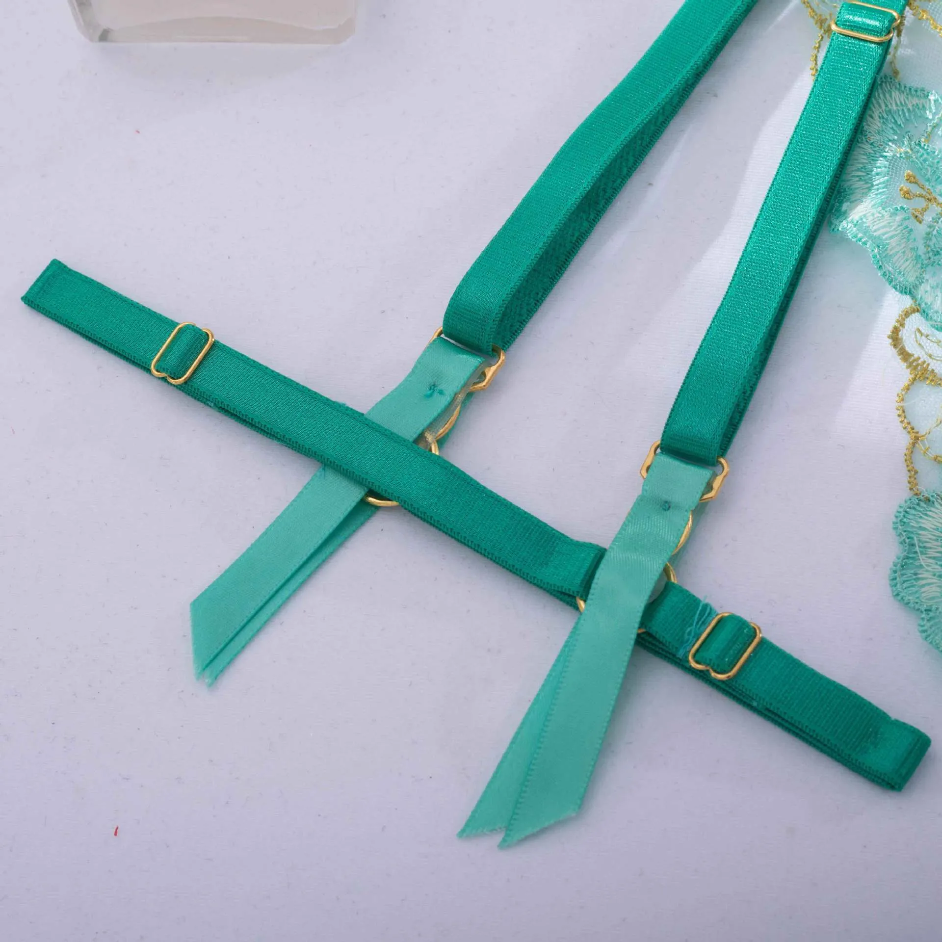 Light green embroidered women's bra and bikini set in three-point style.
