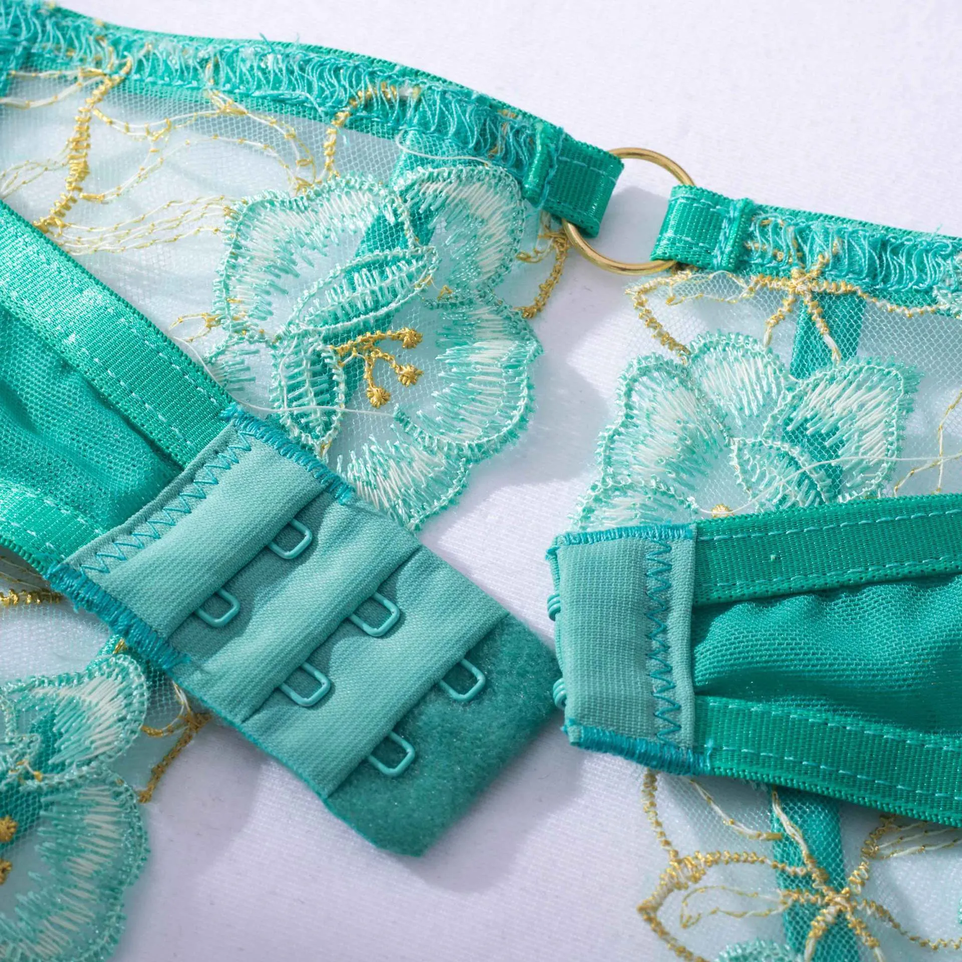 Light green embroidered women's bra and bikini set in three-point style.