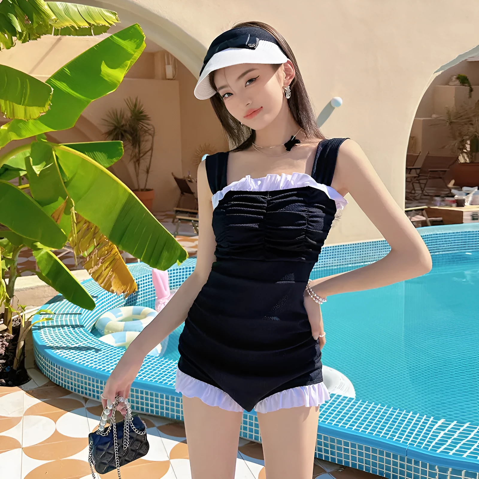 Women's solid colour one-piece jumpsuit swimsuit with suspender straps on a hanger.