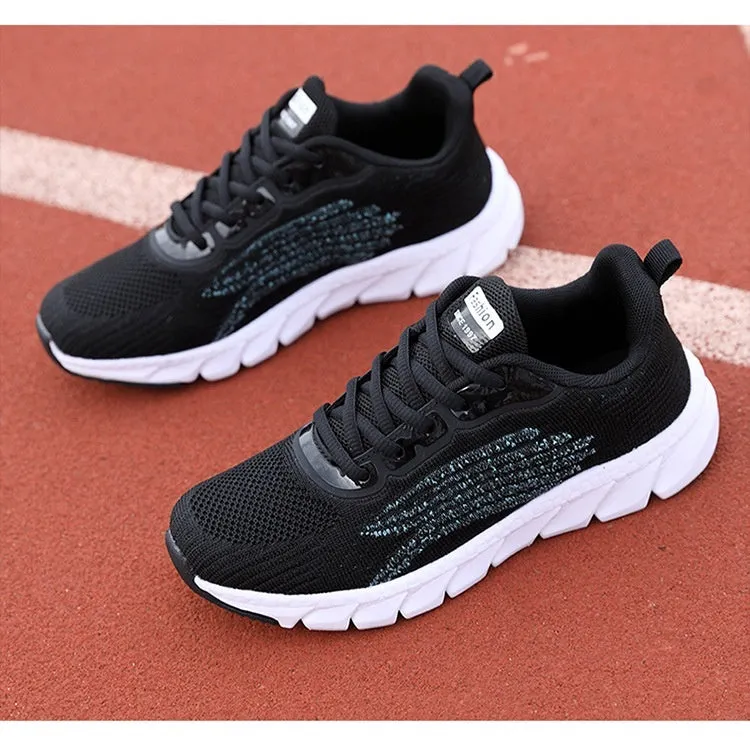 Women's black and white casual running sneakers with cross strap design and MD sole