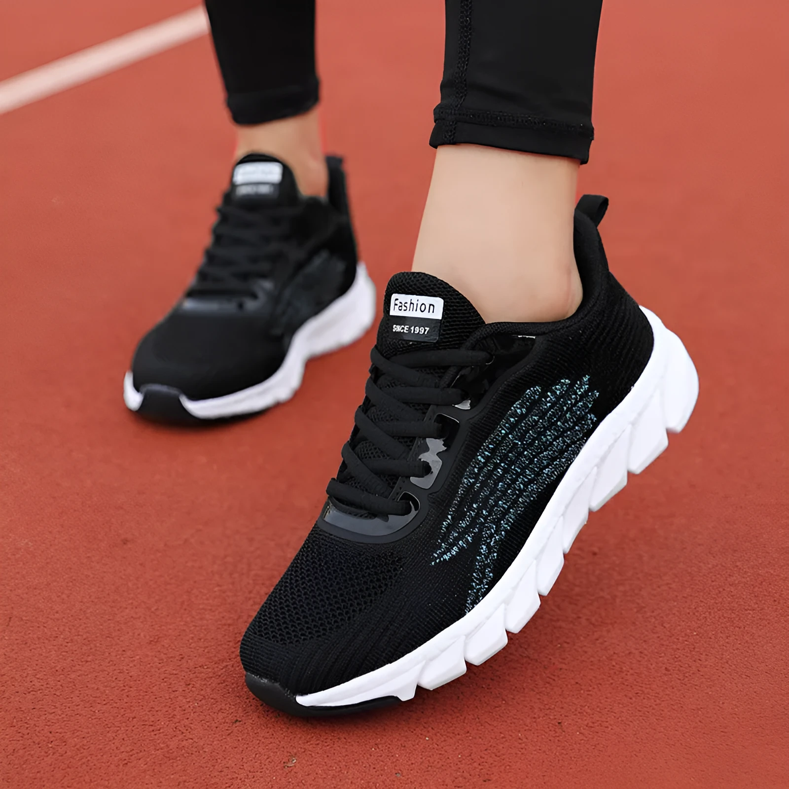 Women's black and white casual running sneakers with cross strap design and MD sole