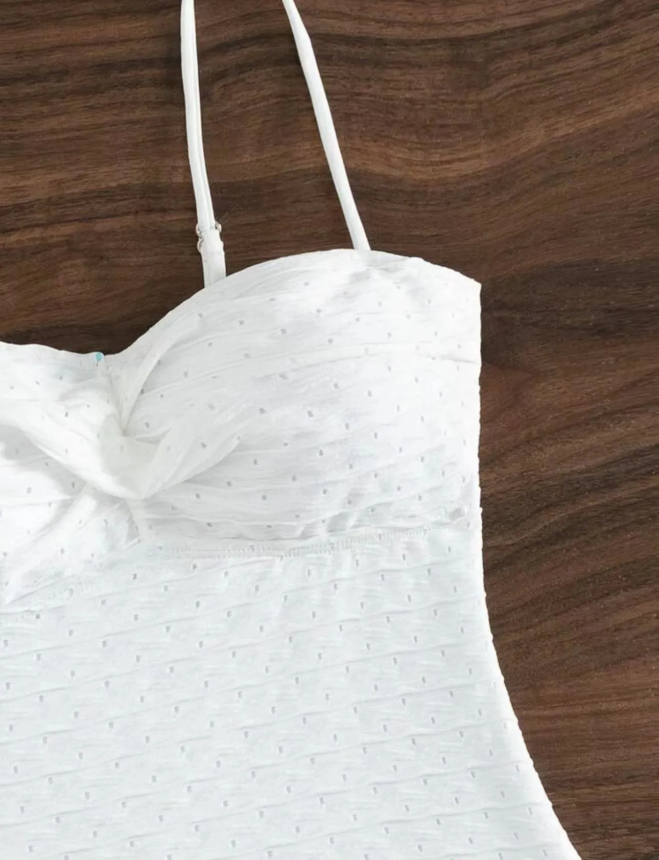 White women's one-piece swimsuit with sling style and brief cut design on mannequin