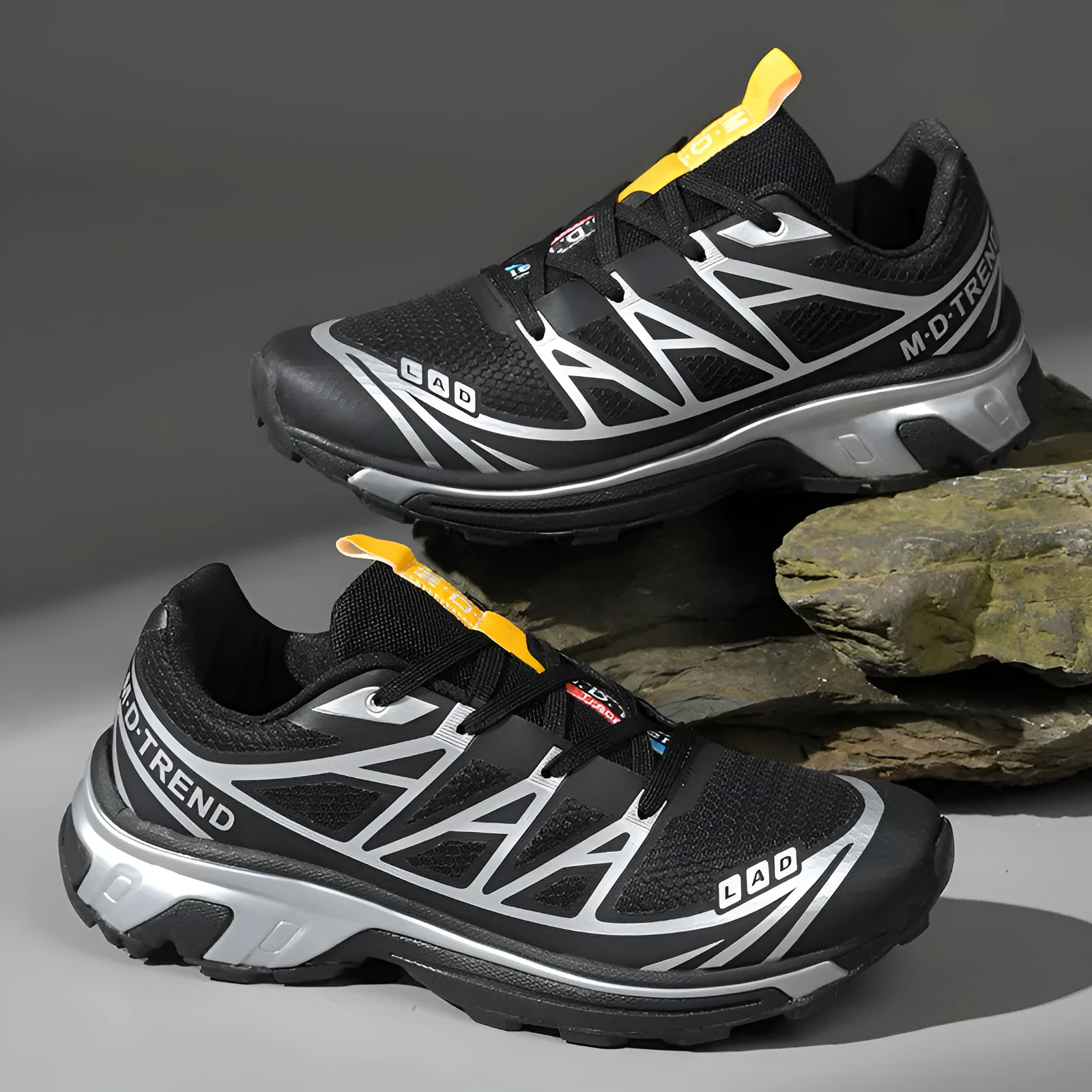 Pair of low-top hiking shoes in artificial leather with a mesh lining and rubber sole.