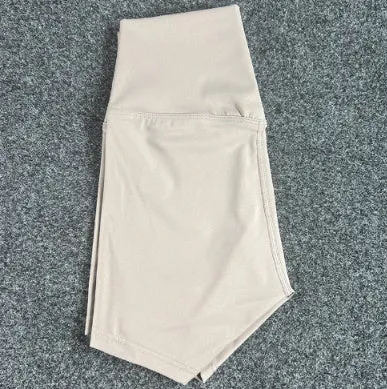 Women's high-waisted nylon yoga shorts in a selection of colours on a neutral background.