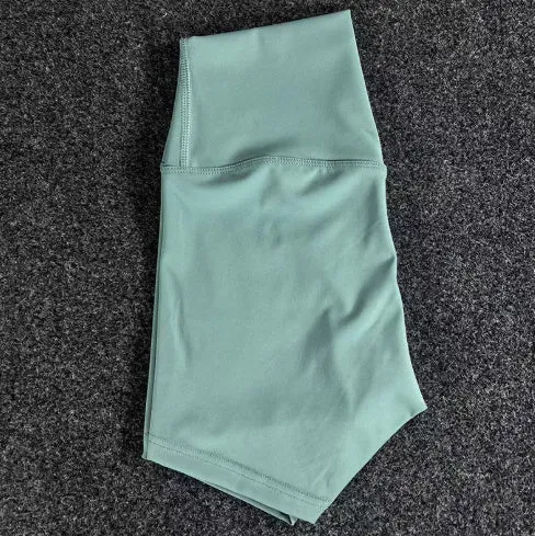 Women's high-waisted nylon yoga shorts in a selection of colours on a neutral background.