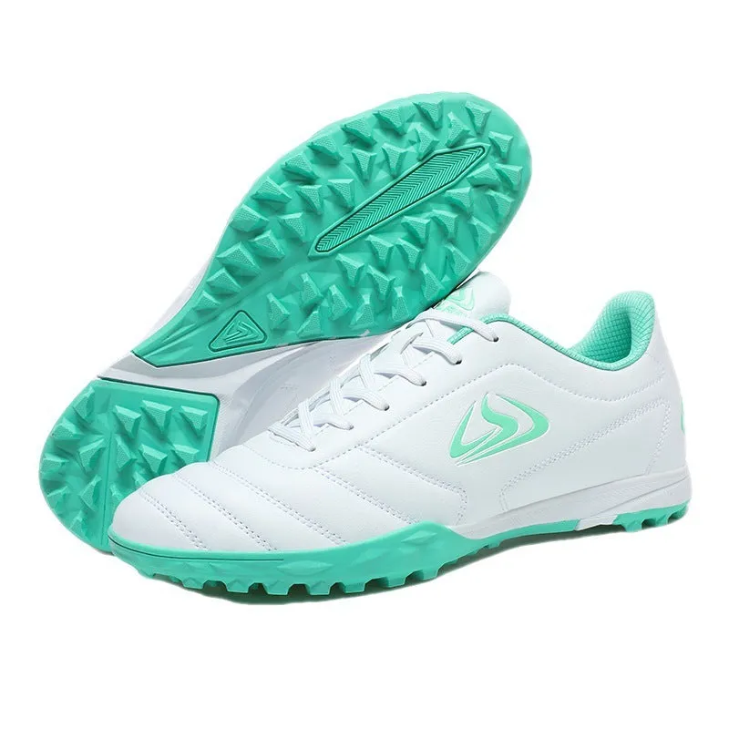 Low top football shoes with synthetic leather upper and rubber sole in black and white broken nails colour.
