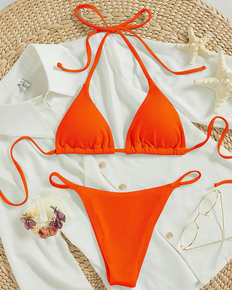 Women's lace up bikini swimsuit in multiple colours on a mannequin, showing front and back design