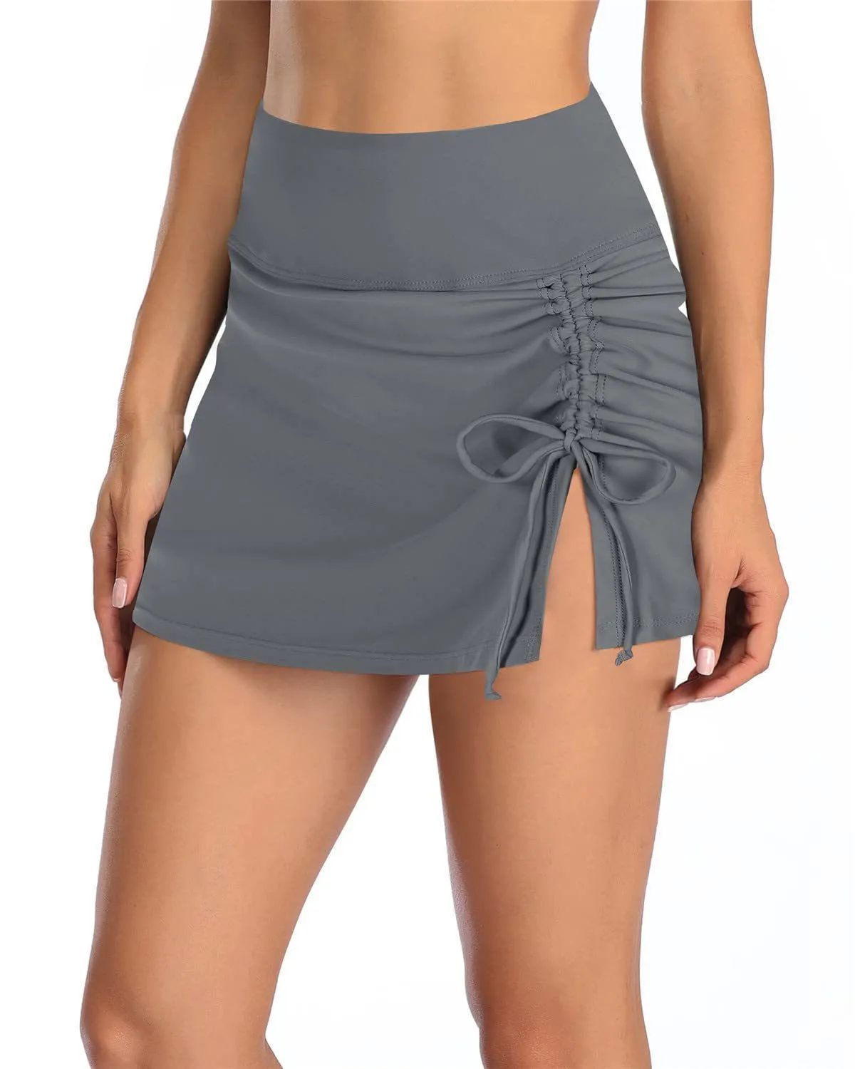 Women's solid colour swimming trunks with lace detail on polyester fabric.