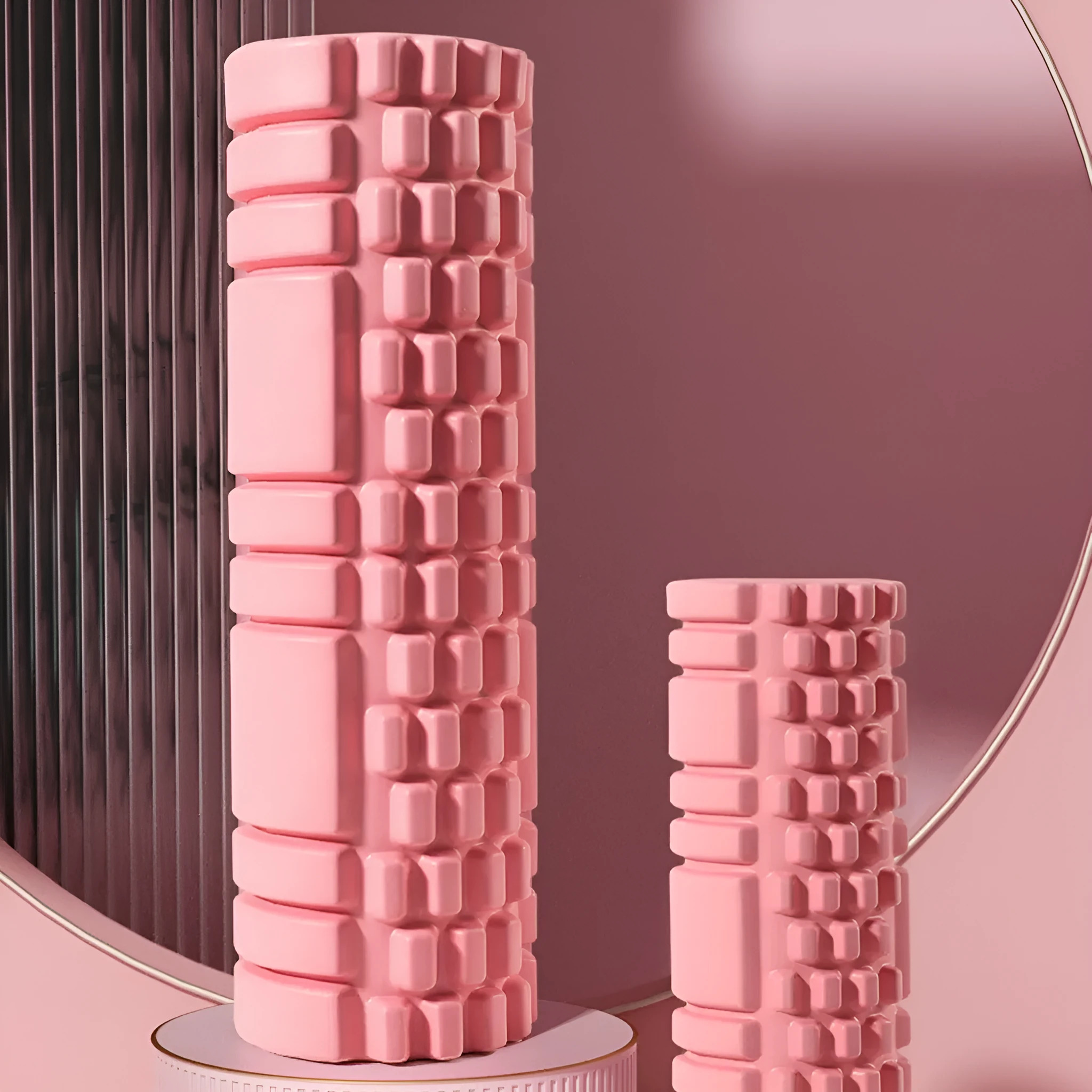A firm EVA foam roller for fitness and muscle recovery, shown in a selection of colours including pink, blue, and grey.