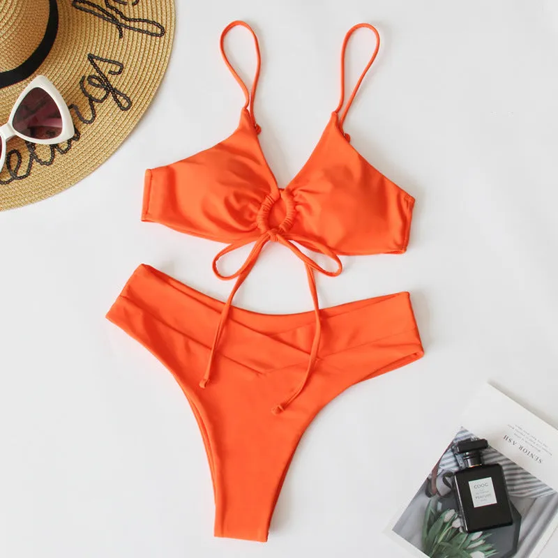 Women's solid colour bikini swimsuit with a tied bow and split leg briefs