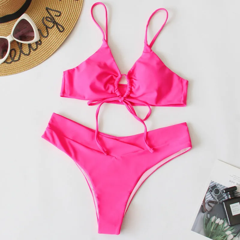 Women's solid colour bikini swimsuit with a tied bow and split leg briefs