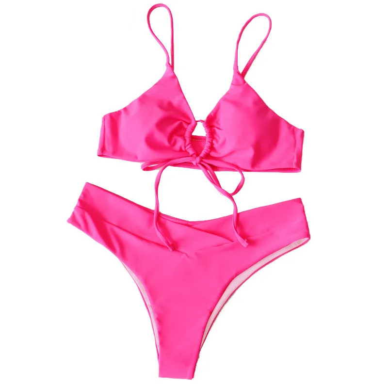 Women's solid colour bikini swimsuit with a tied bow and split leg briefs