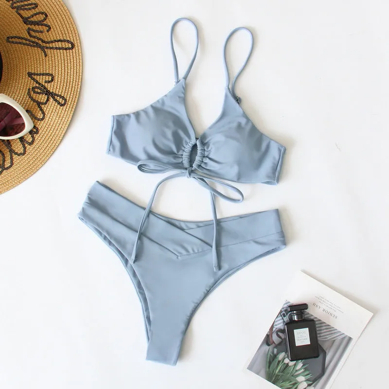 Women's solid colour bikini swimsuit with a tied bow and split leg briefs