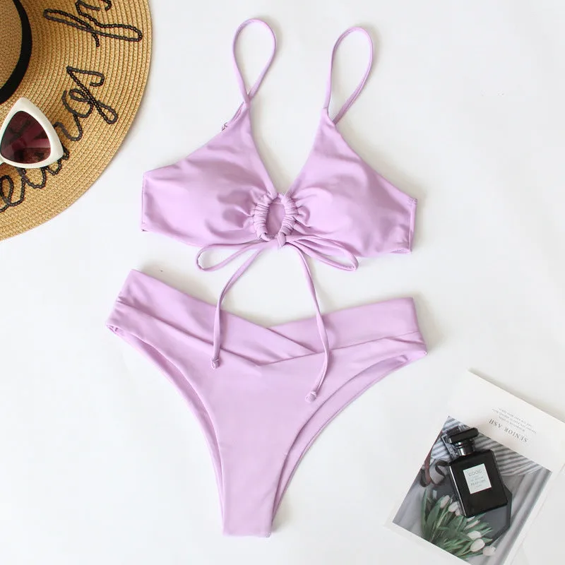 Women's solid colour bikini swimsuit with a tied bow and split leg briefs