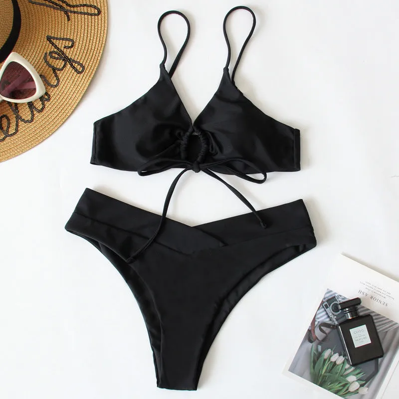 Women's solid colour bikini swimsuit with a tied bow and split leg briefs