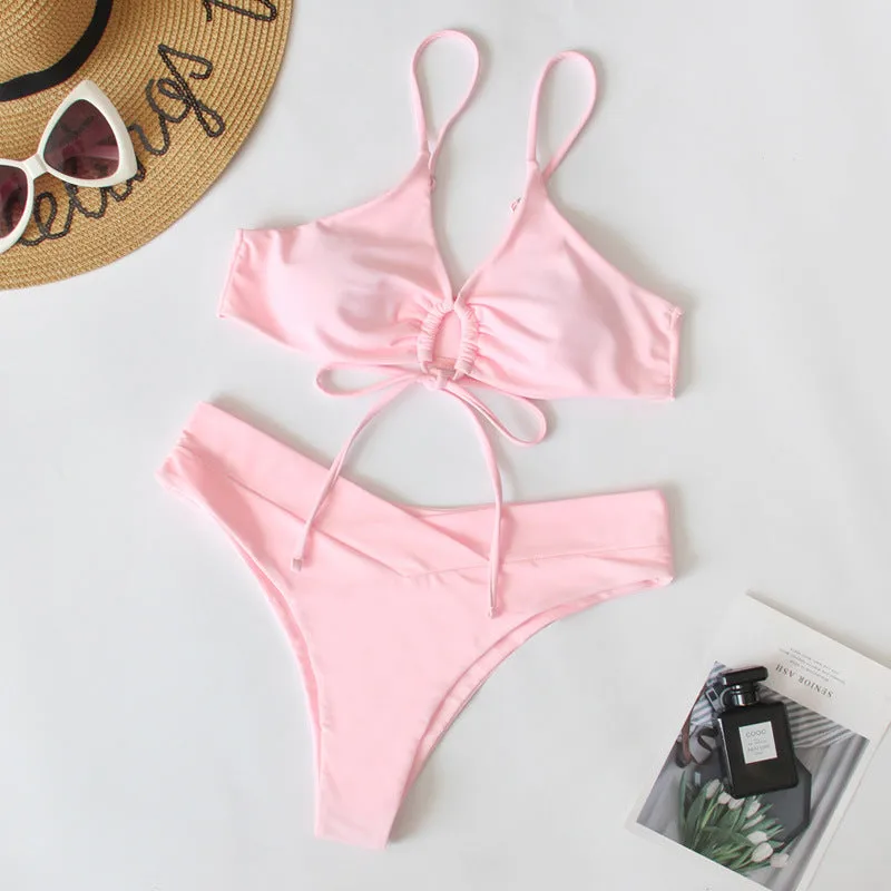 Women's solid colour bikini swimsuit with a tied bow and split leg briefs