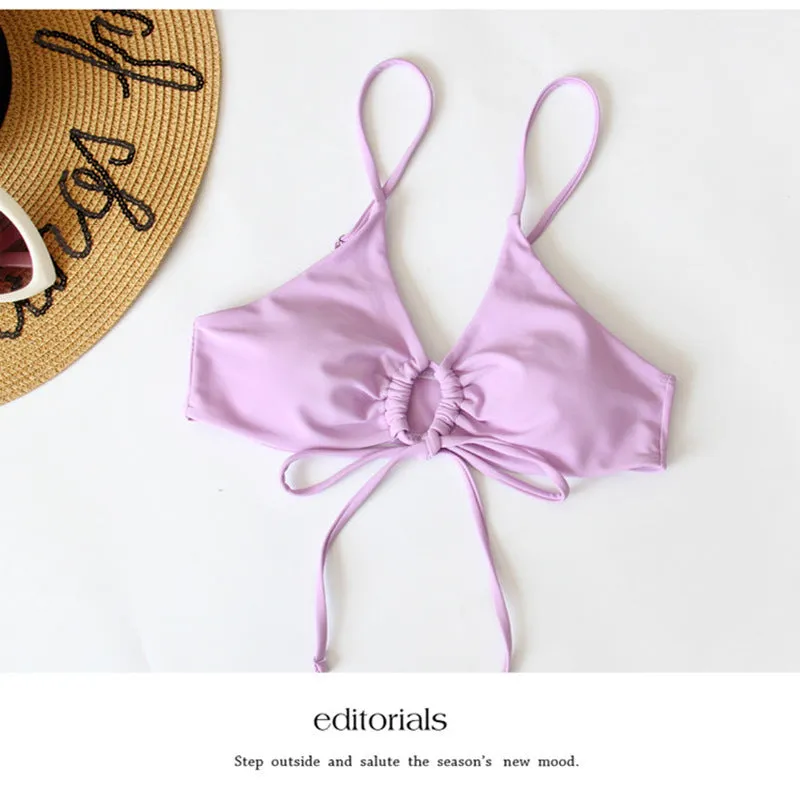 Women's solid colour bikini swimsuit with a tied bow and split leg briefs
