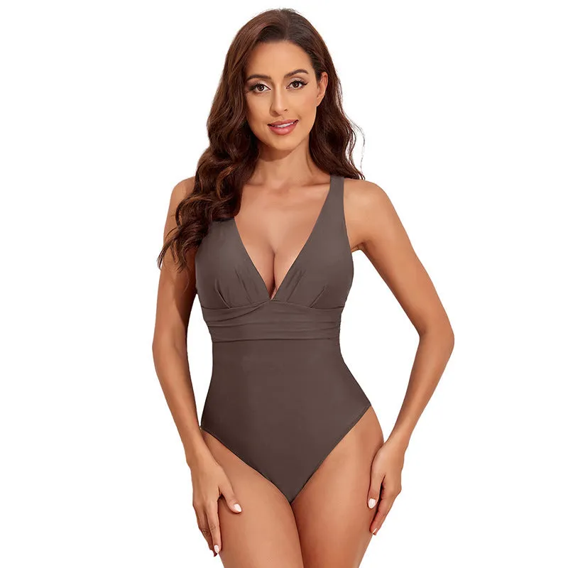 Women's solid colour cross shoulder one-piece nylon swimsuit on a model.