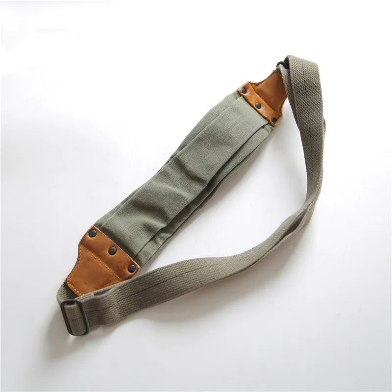 Green American retro military-style chest bag made of washed canvas with Italian leather accents