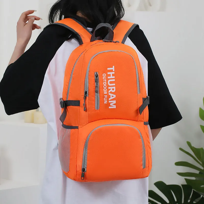 Dark blue folding outdoor backpack with straps, showing its large capacity and air pillow belt.