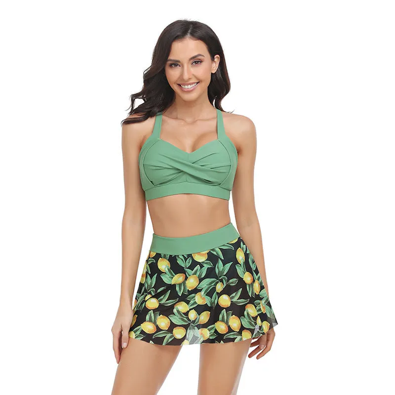 Women's one-piece swimsuit with an attached black tulle skirt, showing the split design.