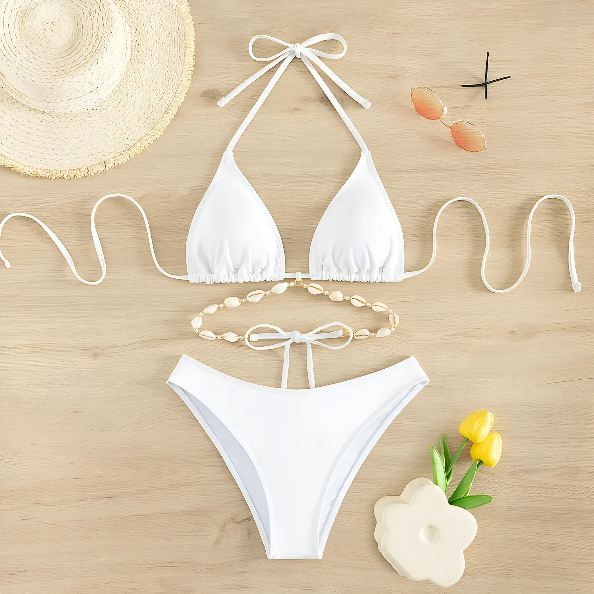 White halter neck lace-up bikini briefs for women on a plain background.