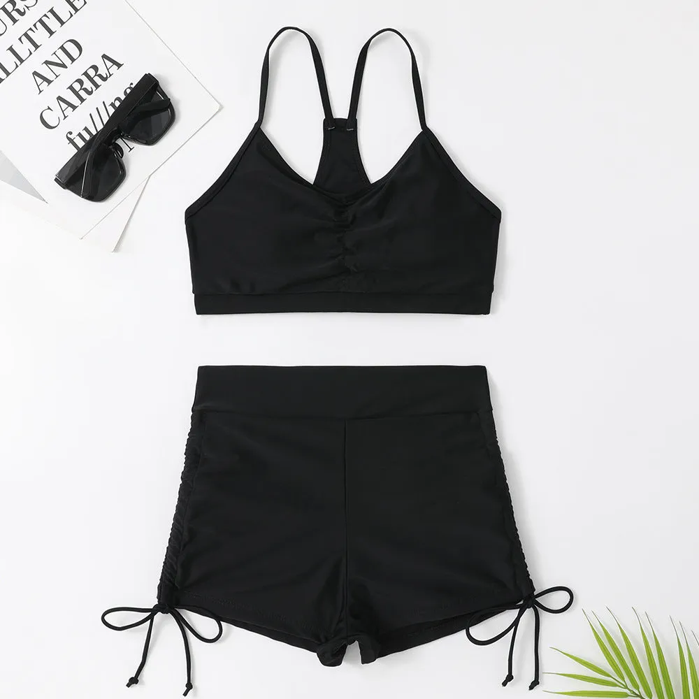 Women's black or purple high-waist split bikini swimsuit with sleeveless top and shorts.