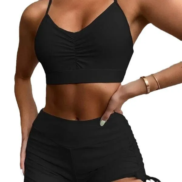 Women's black or purple high-waist split bikini swimsuit with sleeveless top and shorts.
