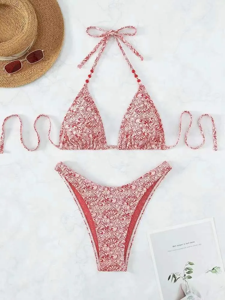 Women's flower pattern halter bikini top and shorts set in emerald green.