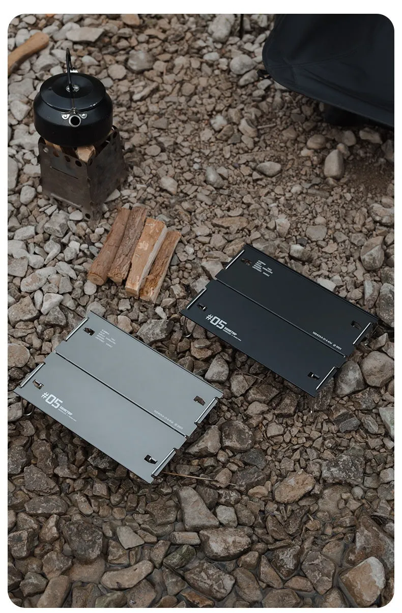 Outdoor 05 Series aluminium alloy folding table shown folded and unfolded in black and grey colours.