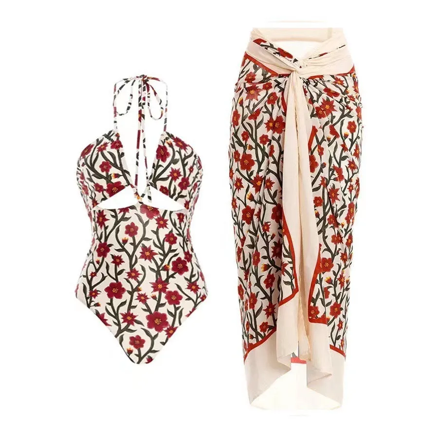 Female model wearing two-piece halter neck swimsuit with floral print and hollow-out gauze skirt cover-up